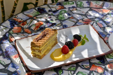 Téléchargez les photos : Pièce de gâteau dans une assiette blanche sur la table - en image libre de droit