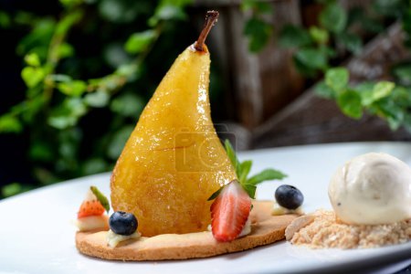 Photo for Delicious dessert pear with caramel , berries  and ice cream - Royalty Free Image