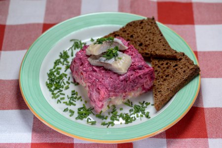 a closeup shot of  black bread with dressed herring or herring under a fur coat