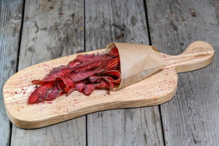 Photo for Basturma dried meat on a wooden board - Royalty Free Image