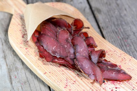 Photo for Basturma dried meat on a wooden board - Royalty Free Image