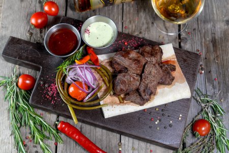 Photo for Grilled meat and vegetables with sauces - Royalty Free Image