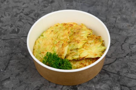 Photo for Fried potato pancakes in paper container - Royalty Free Image