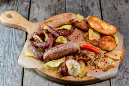 Photo for Pretzels, bratwurst ,sauerkraut and pepper on wooden table - Royalty Free Image