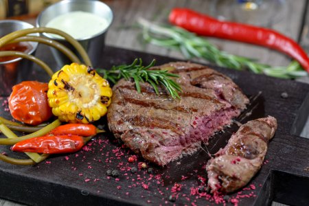 Photo for Grilled  steak with spices and herbs on background, close up - Royalty Free Image