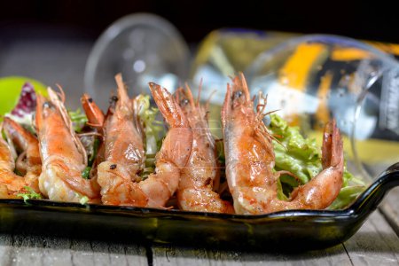 Photo for Shrimps with lime and wine on wooden table - Royalty Free Image