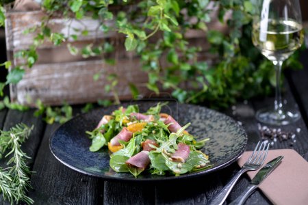Téléchargez les photos : Salade fraîche avec roquette et jambon et verre de vin - en image libre de droit