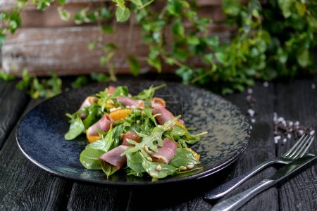Photo for Fresh salad with arugula and ham on  plate - Royalty Free Image