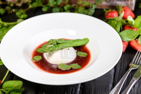 Photo for Asparagus and poached egg,strawberries on background, close up - Royalty Free Image