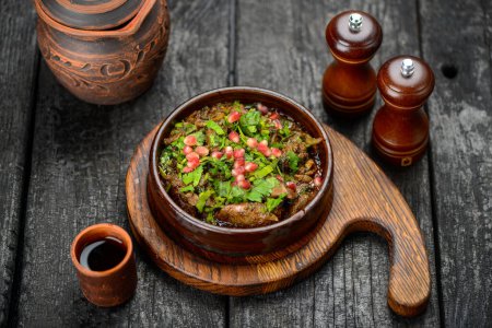 Photo for Baked meat in a pan with greens and pomegranate berries - Royalty Free Image