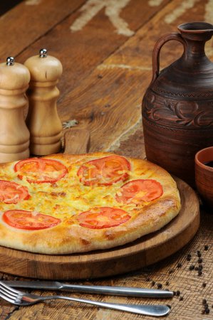 Photo for Georgian flatbread with meat and tomatoes on board - Royalty Free Image
