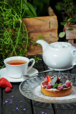 Photo for Tart cake with berries , fruits and tea on background, close up - Royalty Free Image