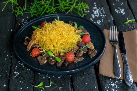 Photo for Plate of fried beef with cheese and tomatoes - Royalty Free Image