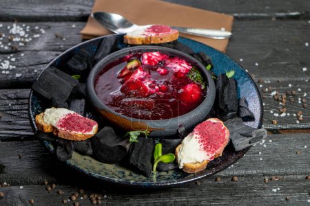 Téléchargez les photos : Soupe rouge maison avec caviar et herbes sur une planche rustique - en image libre de droit