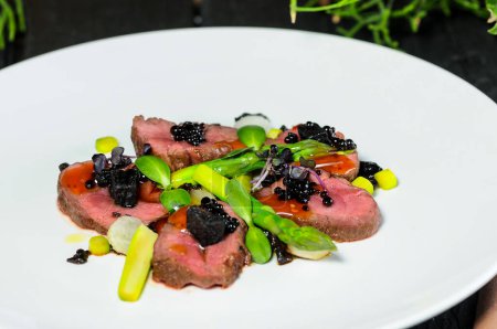 Photo for Beef carpaccio with black caviar, close up - Royalty Free Image