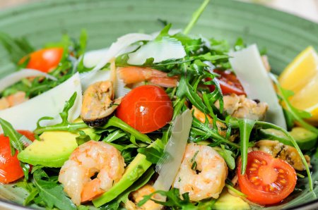 Photo for Tasty salad with shrimps and avocado on wooden table - Royalty Free Image