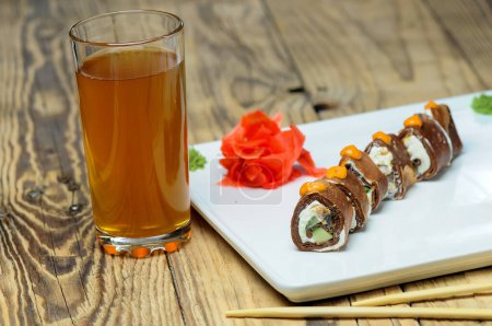 Téléchargez les photos : Cuisine japonaise - rouleaux de maki sur l'assiette et boisson - en image libre de droit