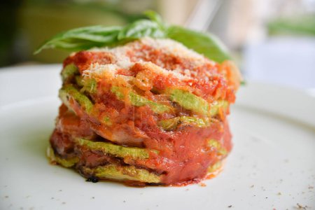 Photo for Dish with minced zucchini  and tomatoes and basil leaves - Royalty Free Image