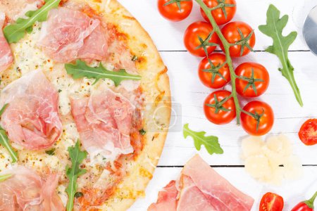 Photo for Ham pizza prosciutto from above close up baking ingredients on wooden board wood - Royalty Free Image