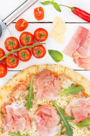 Téléchargez les photos : Ham pizza prosciutto from above close up portrait format baking ingredients on wooden board wood - en image libre de droit