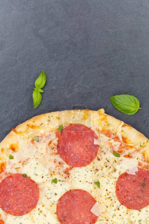 Photo for Pizza salami from above copyspace copy space portrait format close up on a slate vertical - Royalty Free Image