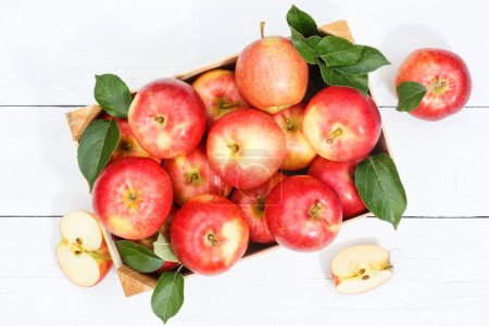 Foto de Apples apple fruits fruit from above autumn fall box with leaves wooden board - Imagen libre de derechos