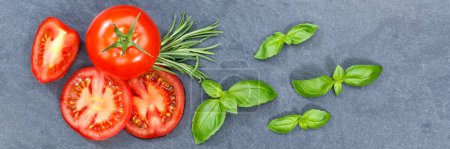 Téléchargez les photos : Tomatoes tomatos vegetables with basil from above banner slate top view - en image libre de droit