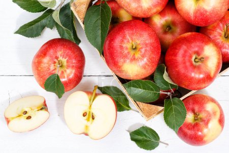 Foto de Apple fruit apples fruits from above autumn fall summer box with leaves wooden board - Imagen libre de derechos