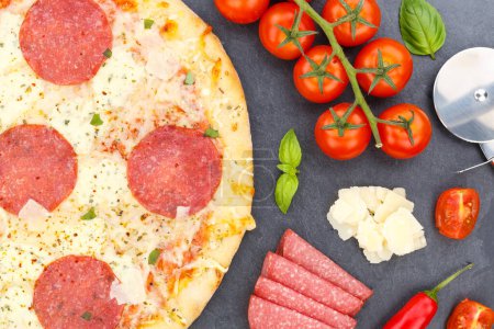 Photo for Pizza salami from above baking ingredients close up on a slate - Royalty Free Image