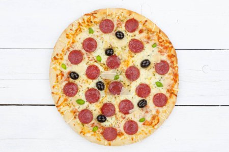 Foto de Pizza pepperoni salami from above on wooden board wood - Imagen libre de derechos