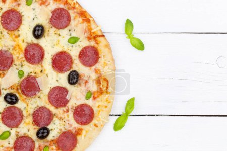 Foto de Pizza pepperoni salami from above copyspace copy space close up on wooden board wood - Imagen libre de derechos