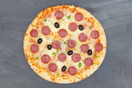 Photo for Pizza pepperoni salami from above on a slate - Royalty Free Image