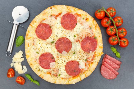 Photo for Pizza salami from above baking ingredients on a slate - Royalty Free Image