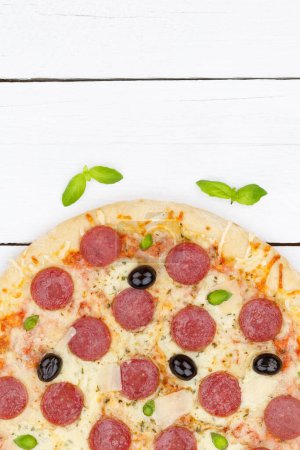 Foto de Pizza pepperoni salami from above copyspace copy space portrait format close up on wooden board wood - Imagen libre de derechos