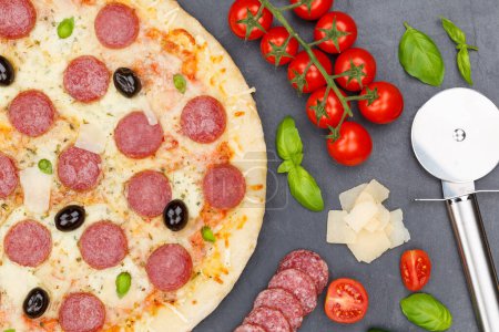 Photo for Pizza pepperoni salami from above baking ingredients close up on a slate - Royalty Free Image