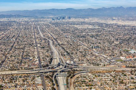 Photo for Aerial view of highway interchange Harbor and Century Freeway traffic with downtown city Los Angeles, USA - Royalty Free Image