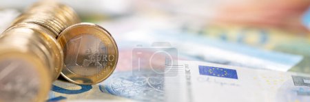 Photo for One Euro coin money saving pay paying finances with copyspace copy space panorama rich - Royalty Free Image