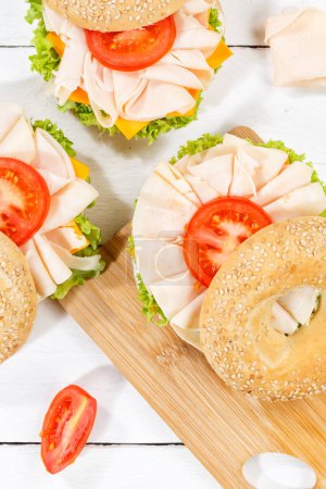 Photo for Bagel sandwich with chicken breast ham for breakfast from above portrait format - Royalty Free Image