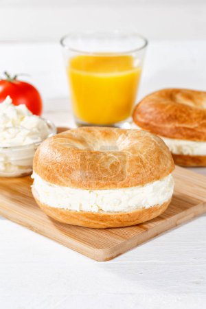 Photo for Bagel sandwich with fresh cream cheese for breakfast portrait format - Royalty Free Image