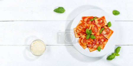 Photo for Ravioli pasta meal from Italy for lunch eat dish with tomato sauce top view on a plate and wooden board copyspace copy space - Royalty Free Image