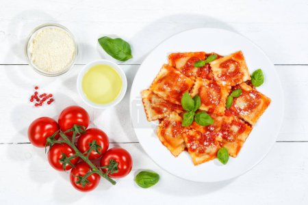 Photo for Ravioli pasta meal from Italy for lunch eat dish with tomato sauce top view on a plate and wooden board - Royalty Free Image