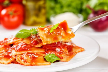 Photo for Ravioli pasta meal from Italy eat for lunch dish with fork and tomato sauce on a plate - Royalty Free Image