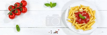 Photo for Penne Rigatoni Rigate pasta top view meal from Italy eat lunch with tomato sauce on a plate copyspace copy space panorama - Royalty Free Image