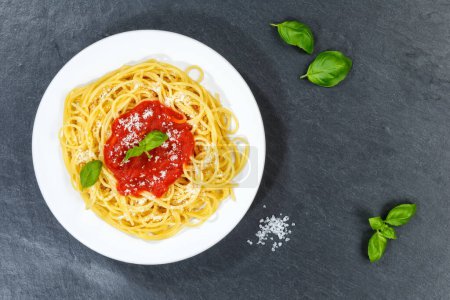 Photo for Spaghetti meal from Italy eat pasta lunch with tomato sauce from above on a slate - Royalty Free Image