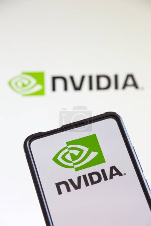 Photo for Stuttgart, Germany - July 20, 2023: Nvidia logo of the software company which designs graphics processing units GPU on a mobile phone and computer screen in Stuttgart, Germany. - Royalty Free Image