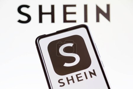 Photo for Stuttgart, Germany - July 20, 2023: Shein logo online marketplace ecommerce on a mobile phone and computer screen in Stuttgart, Germany. - Royalty Free Image