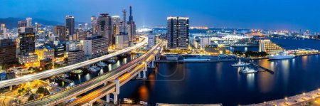 Photo for Kobe skyline from above with port and elevated road traffic panorama at twilight in Japan - Royalty Free Image