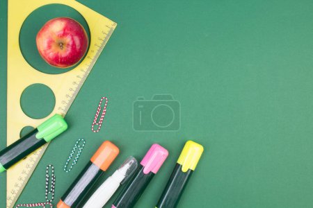 Photo for Back to school. Stationery on a green table. Office desk with copy space. Flat lay - Royalty Free Image