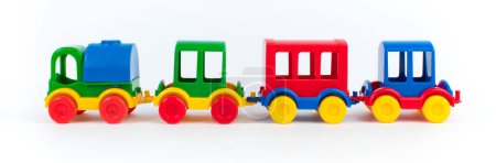 Foto de Juguete infantil, una locomotora de vapor multicolor sobre un fondo blanco. banner, panorama - Imagen libre de derechos