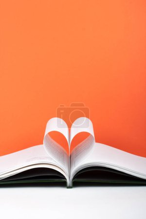 Photo for Old open hardback book, page decorate into a heart shape for love in Valentine's. love with open book heart - Royalty Free Image
